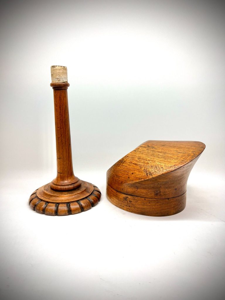 Elegant Art Deco milliner’s hat form on a carved wooden stand, France or Germany, circa 1920–1930.