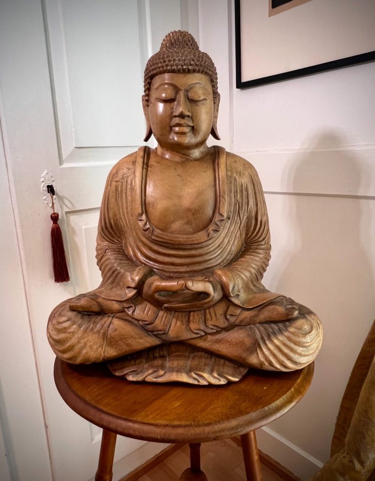 Hand-carved hardwood Buddha sculpture seated in meditation